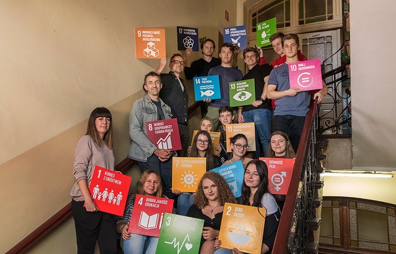 Young people holding UN SDG goal cards
